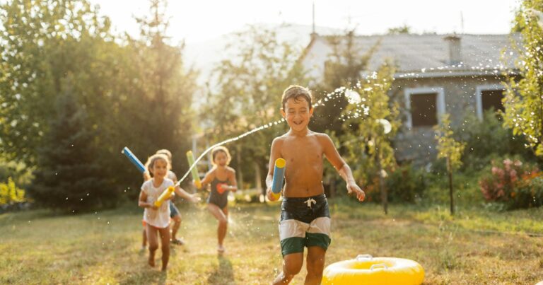 children having fun spraying