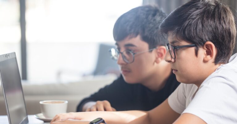 two boys working together