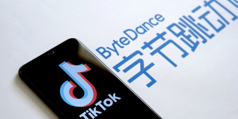 Phone with the TikTok logo next to a ByteDance sign gID 7