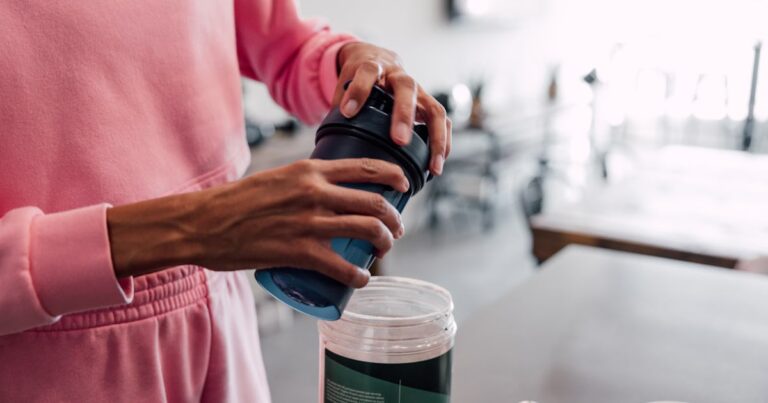 woman preparing protein shake